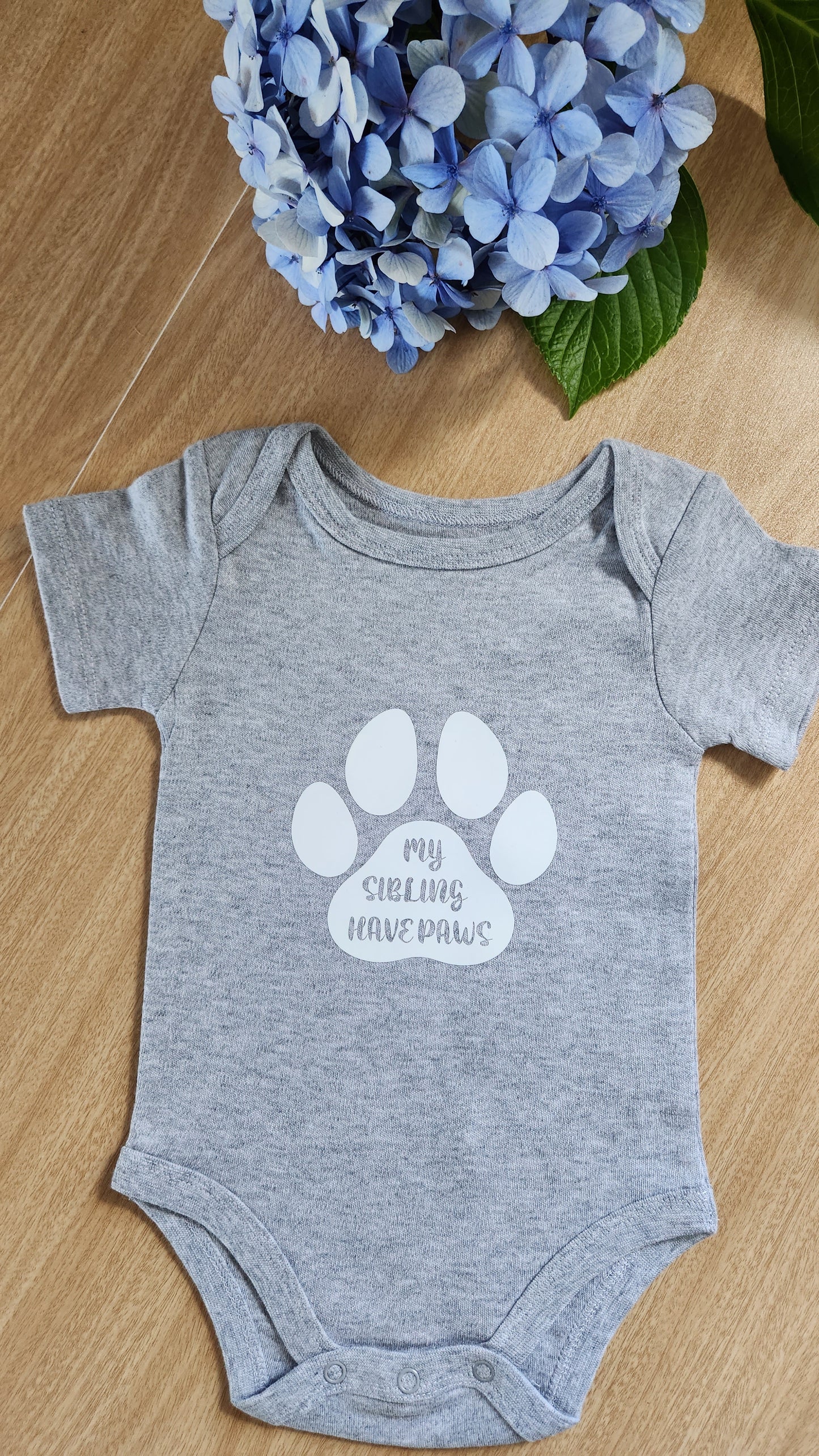 'My siblings have paws' baby onesie (short-sleeve)